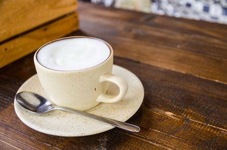 white coffee cup on wooden table