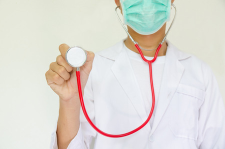 white coat doctor with green mask rise red stethoscope for listenの写真素材