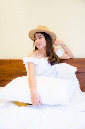 asian girl on white bedの写真素材