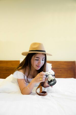 asian girl on white bedの写真素材