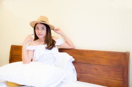 asian girl on white bedの写真素材