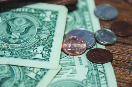 close up of dollar bill and coin on pocketの写真素材
