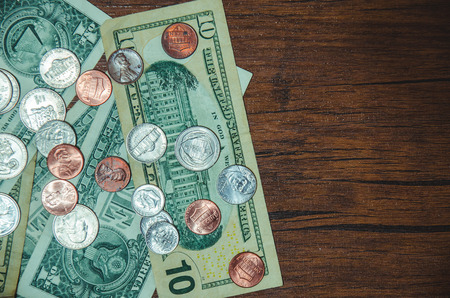 dollar bill with coin  on top viewの写真素材