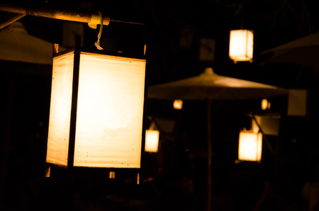 thai ancient lamp hanging on woodの写真素材