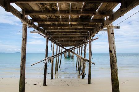 under of old bridge on beachの写真素材