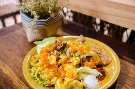 thai style noodle on wooden table and dry flowerの写真素材