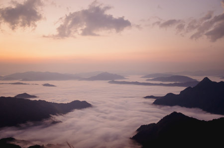 sunrise with dark mountain and mist