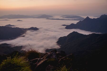 sunrise with dark mountain and mistの写真素材