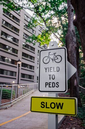 yield to peds sign with building backgroundの写真素材