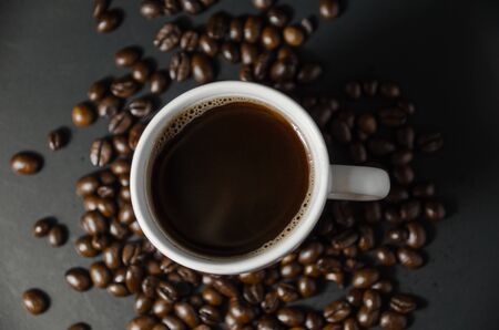 white coffee cup with coffee beans on top viewの写真素材