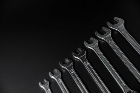 sort of silver wrench on black background