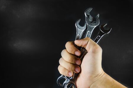 hand hold wrench on blackgroundの写真素材