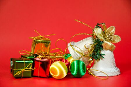 group of bell, ball and gift in christmas on red backgroundの写真素材