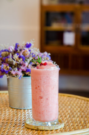 stawberrt smoothie yogurt in high glass on wooden tableの写真素材