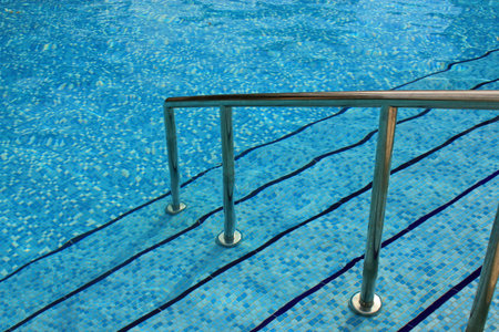 Steps into a swimming pool symbolizing summer, vacation and relaxation