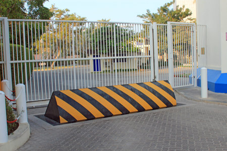 Yellow and black security barrier in front of security gates symbolizing protection, security and...