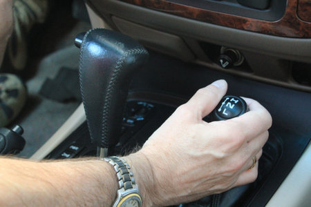 Changing gear in a car symbolizing safety, 4 wheel drive and hands off the steering wheel