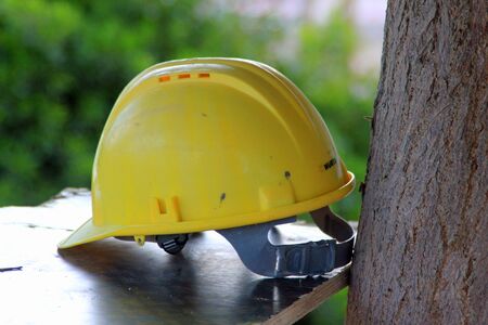 Yellow safety helmet symbolizing health and safety and the construction industryの写真素材