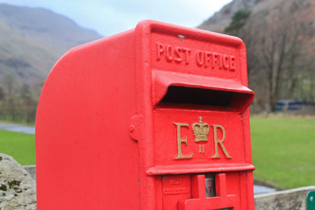 Isolated British red post box in the countryside representing the far reaches of communication