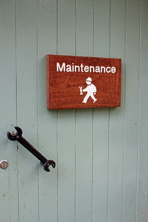 Sign for maintenance showing character man with a spanner and spanner door handle symbolizing home improvements, DIY and professional maintenanceの写真素材