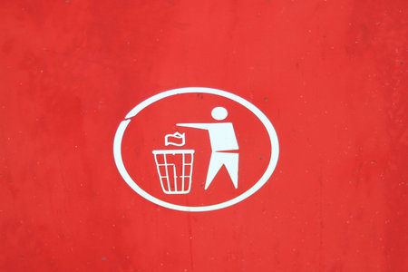 White rubbish disposal symbol on a red backgroundの写真素材