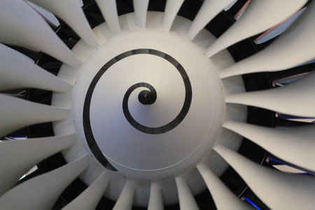 Close up of a plane engine with fan blades for sending air into the combustor