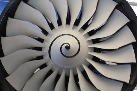 Close up of a plane engine with fan blades for sending air into the combustor