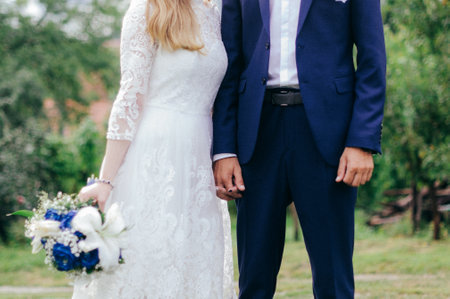 wedding couple in the park on the background of green treesの写真素材