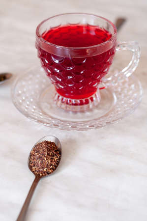 Red tea cup isolated on black and yellow backgroundの写真素材