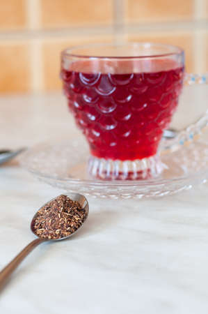 Red tea cup isolated on black and yellow backgroundの写真素材