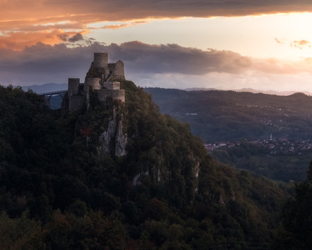 Ruins of medieval castle on top of a hill at sunset.のeditorial素材
