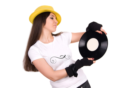 Beautiful Young Woman Disc Jockey in Yellow Hat  holding Disc Recordingの写真素材