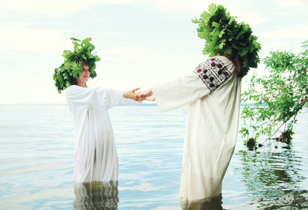 Women in Traditional Slav Dresses Dancing Together
