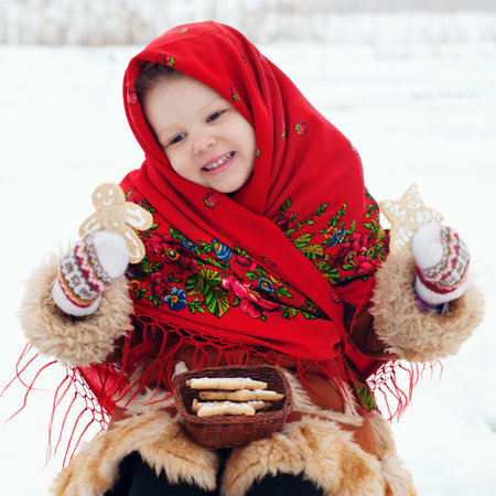 Winter Holidays - Happy winter Vacation at the Countryside. Happy Beautiful Girl in Headscarf....