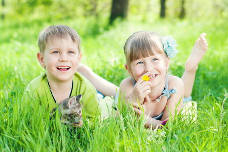 Children playing on Green Grass in the Park - Healthy Lifestyles concept.の写真素材