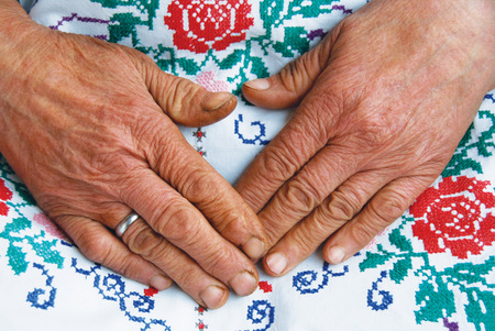 Closeup of an Old Womans Hands - Senior Woman Hands with Handworkの写真素材