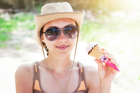 Fashion Portrait of Beautiful Girl Eating Ice Creamの写真素材