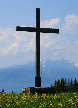 Wooden cross on top of mountain with wonderful viewの写真素材