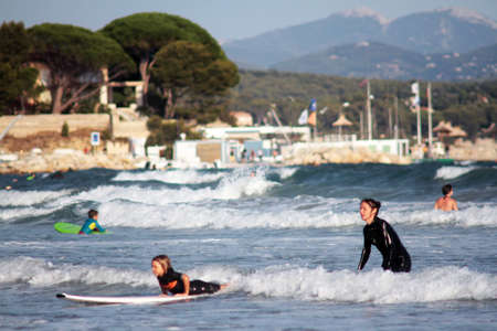 La Ciotat, France - September 11, 2015: Mother teaches child to surf on the beachのeditorial素材