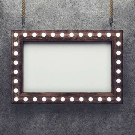 Wooden frame on concrete background illuminated by light bulbs. 3D renderingの写真素材