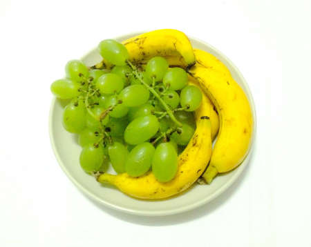 Grapes and bananas on plateの素材