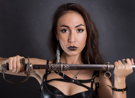 Sexy girl in black lingerie and sword beltの写真素材
