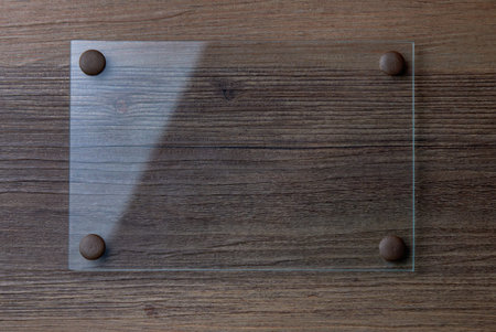 Glass framework on wooden background.
