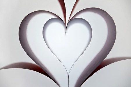 Paper sheets folded as heart.の写真素材