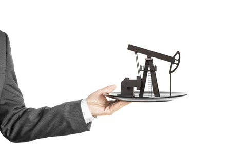 Oil pump on the plate in handの写真素材