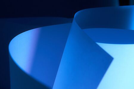 Abstract twisted sheets of blue paper. backround.の写真素材