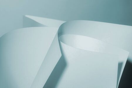 Abstract twisted sheets of blue paper. backround.の写真素材