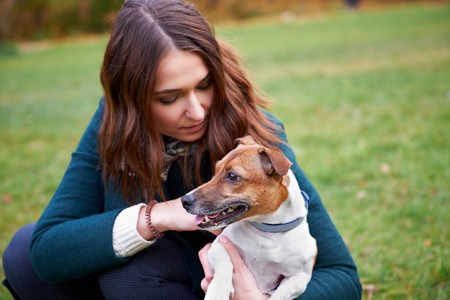 Girl with a dog in parkの写真素材