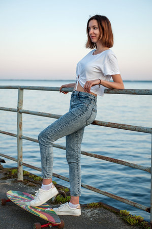 Young hipster girl with longboardの写真素材