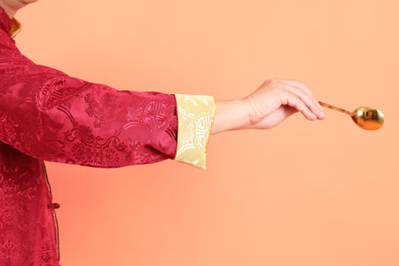Happy Chinese new year. Hand of asian chinese senior man wearing red traditional clothing with...